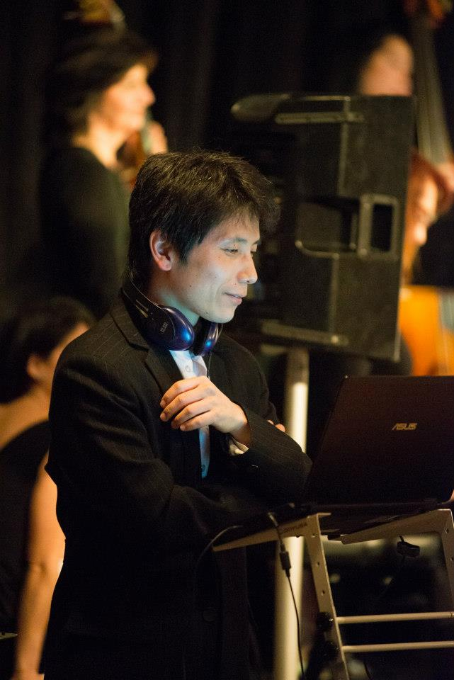 Rick DJing a real milonga with an orchestra blurred in the background